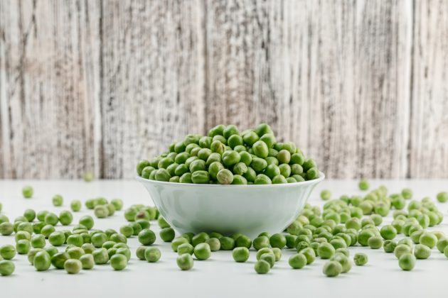 peas-white-bowl-white-grungy-wooden-wall-side-view_176474-5764.jpg